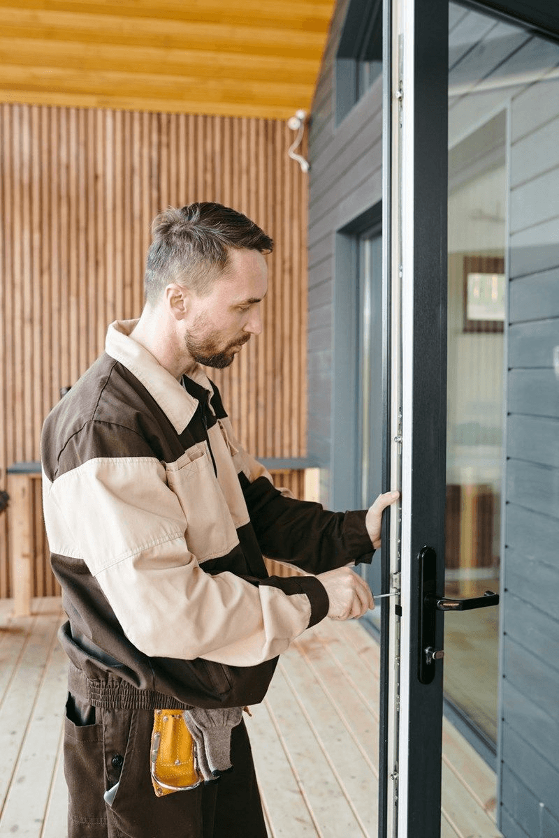 Technician installing a glass storefront door